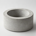 Round cast concrete tabletop fire bowl with recessed centre opening