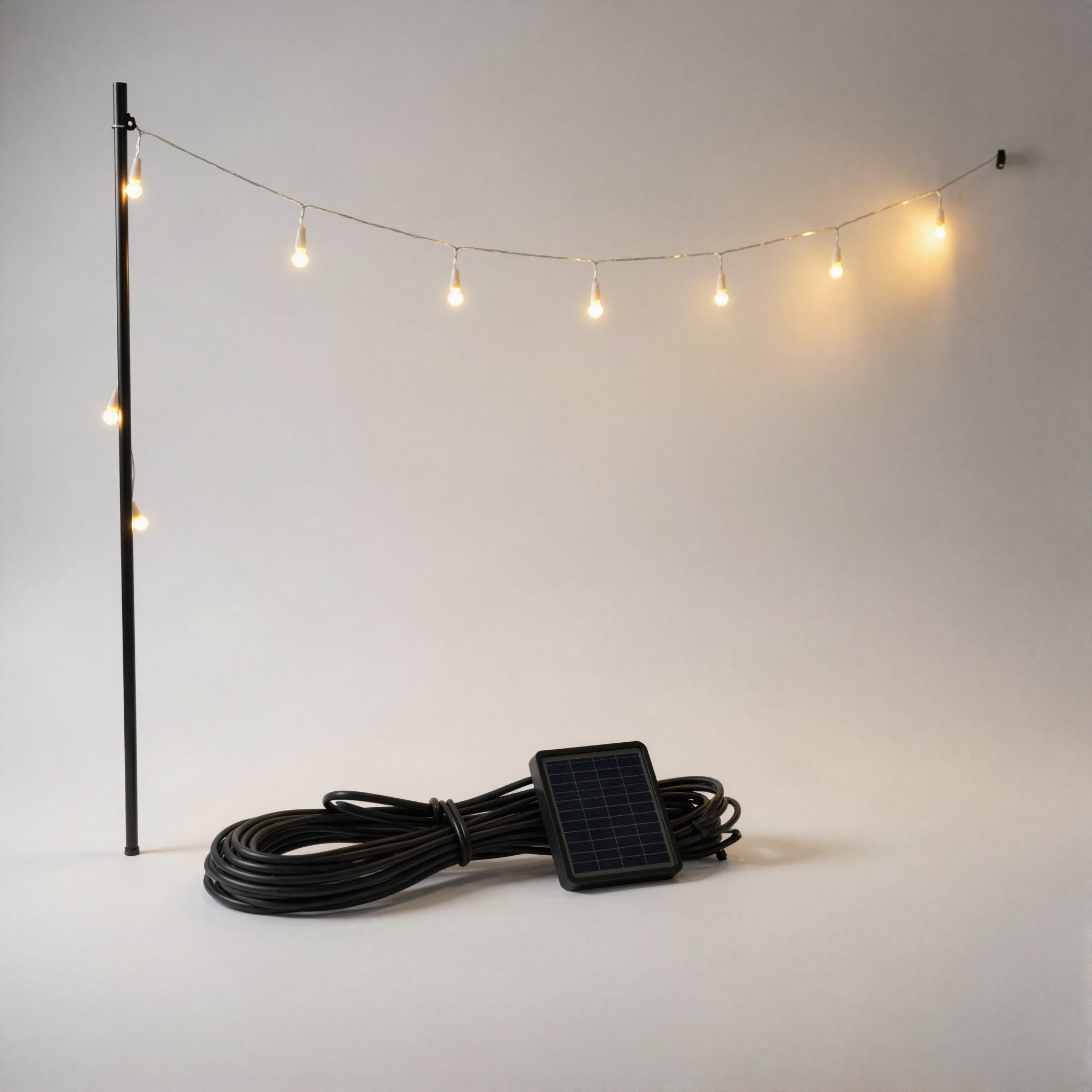 Coiled solar LED icicle light strand with ground-stake solar panel