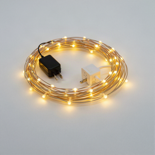 Coiled LED fairy string lights on copper wire with remote control box and plug